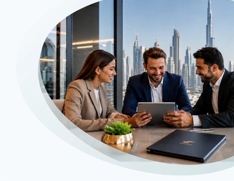 Business partners reviewing UAE visa solutions on a tablet, Dubai skyline beyond the window