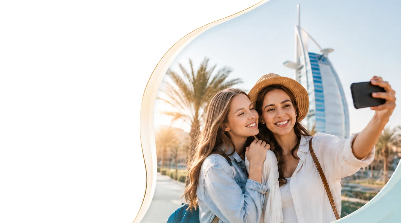 Two travellers taking a selfie in front of the Burj Al Arab in Dubai